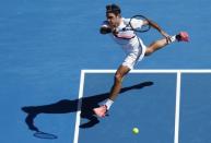 Tennis - Australian Open - Rod Laver Arena, Melbourne, Australia, January 22, 2018. Roger Federer of Switzerland hits a shot against Marton Fucsovics of Hungary. REUTERS/Edgar Su