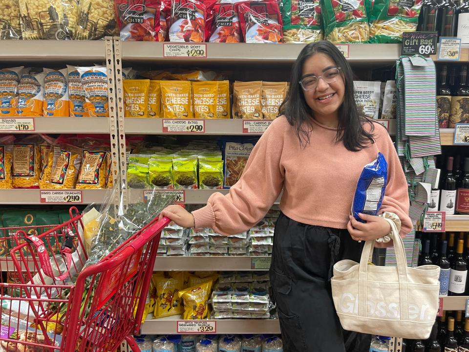 Author Aleenah Ansari with cart in Trader Joe's