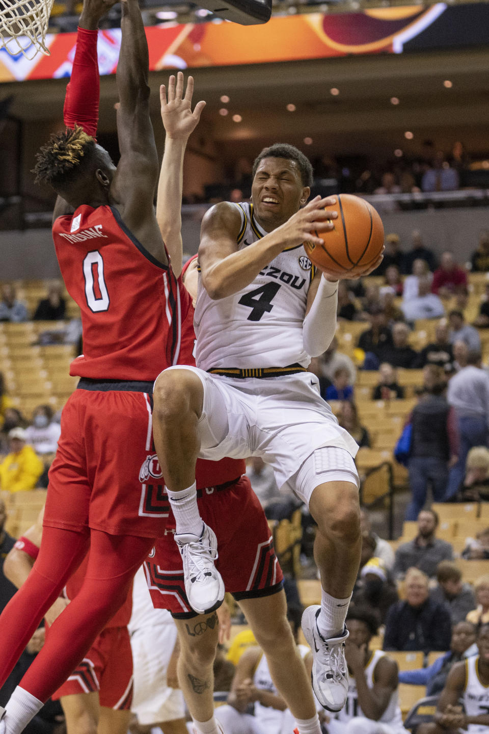 Missouri's Javon Pickett, right, is fouled by Utah's Lahat Thioune, left, during the second half of an NCAA college basketball game Saturday, Dec. 18, 2021, in Columbia, Mo. (AP Photo/L.G. Patterson)