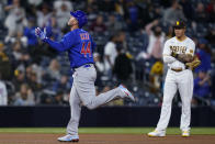 Chicago Cubs' Anthony Rizzo, left, reacts after hitting a two-run home run, next to San Diego Padres third baseman Manny Machado during the seventh inning of a baseball game Tuesday, June 8, 2021, in San Diego. (AP Photo/Gregory Bull)