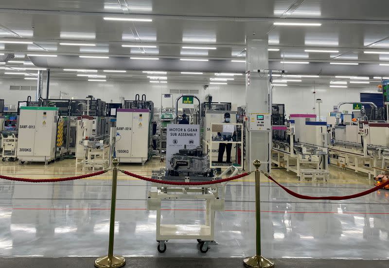 Employees work inside a Toyota Kirloskar Auto Parts factory in Bidadi