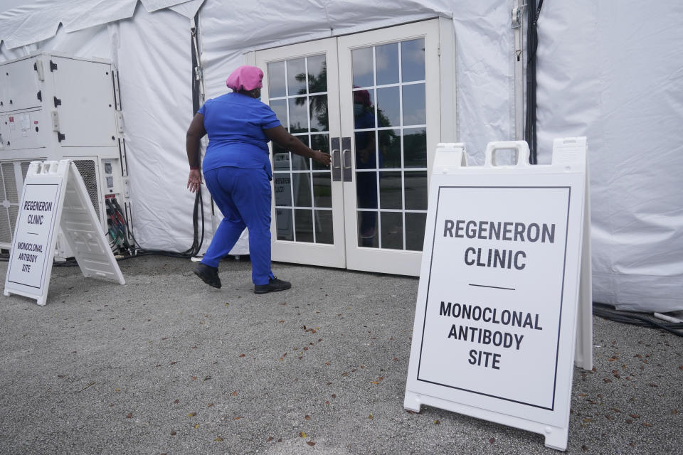 A nurse enters a monoclonal antibody site, Wednesday, Aug. 18, 2021, at C.B. Smith Park in Pembroke Pines. Numerous sites are open around the state offering monoclonal antibody treatment sold by Regeneron to people who have tested positive for COVID-19. (AP Photo/Marta Lavandier)