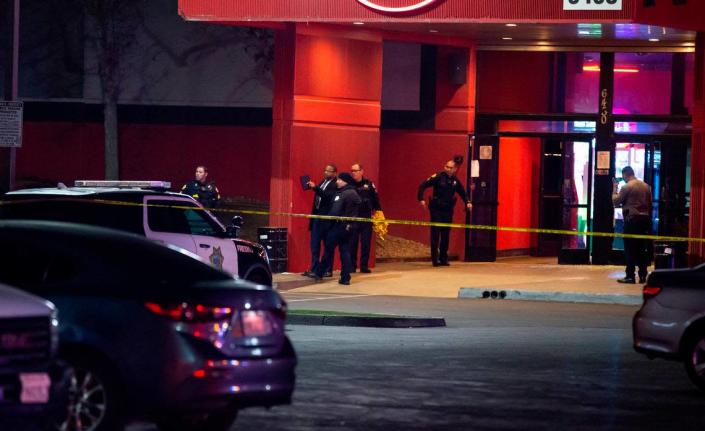 Detectives investigate the scene of a fatal shooting inside a Bowlero bowling alley in northeast Fresno on Friday, Feb. 11, 2022.