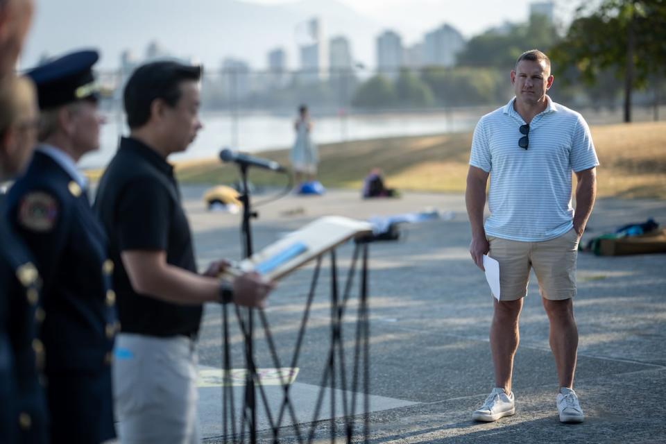 Vancouver Park Board Chair Brennan Bastyovanszky watches as Mayor Ken Sim announces the reopening of the Kitsilano Swimming Pool during a press conference. Sim said the pool has special meaning for many in the city. 