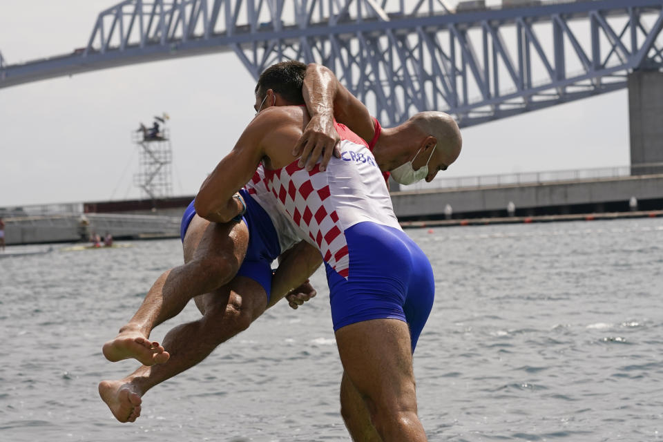 Martin Sinkovic and Valent Sinkovic of Croatia celebrate after winning the gold medal in the men's rowing pair final at the 2020 Summer Olympics, Thursday, July 29, 2021, in Tokyo, Japan. (AP Photo/Darron Cummings