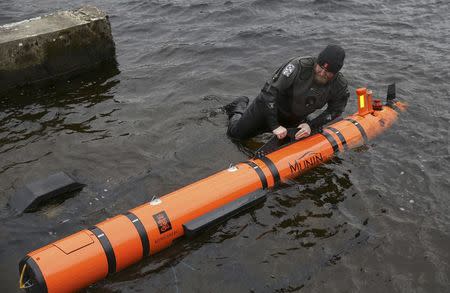 Subsea engineer John Haig launches Munin, an intelligent marine robot, to explore Loch Ness in Scotland, Britain April 13, 2016. REUTERS/Russell Cheyne