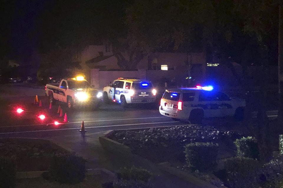 Officers secure a scene of a shooting in Phoenix, Ariz., Sunday, Mar. 29, 2020. At least three Phoenix police officers were shot Sunday night on the city's north side, authorities said. (AP Photo/Ross Franklin)