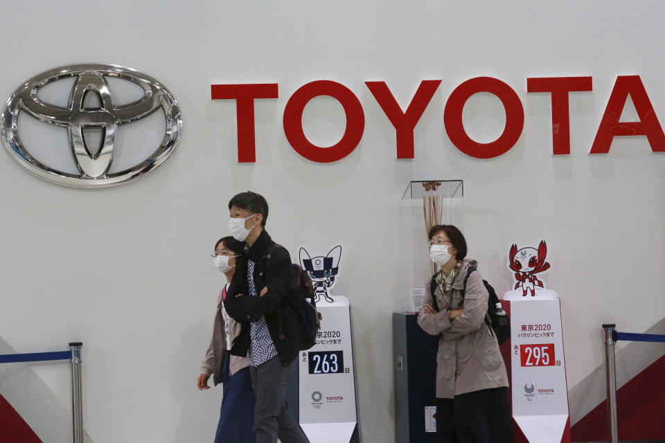 FILE - In this Nov. 2, 2020, file photo, visitors walk at a Toyota showroom in Tokyo. Toyota Motor Corp. has acquired the self-driving division of American ride-hailing company Lyft for $500 million, in a move that underlines the Japanese automaker’s ambitions in that technology, announced Tuesday, April 27, 2021. (AP Photo/Koji Sasahara, File)