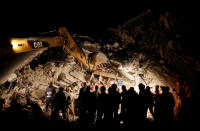 <p>Rescuers work in the night at a collapsed house following an earthquake in Pescara del Tronto, central Italy, August 24, 2016. (Photo: Remo Casilli/Reuters) </p>