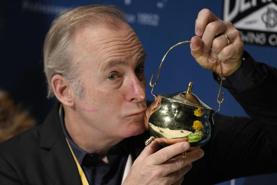 Actor Bob Odenkirk kisses his pudding pot trophy during a a news conference after being honored as Man of the Year by Harvard University's Hasty Pudding Theatricals, Thursday, Feb. 2, 2023, in Cambridge, Mass. (AP Photo/Charles Krupa)