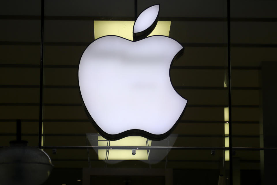 FILE - The Apple logo is illuminated in a store in downtown Munich, Germany, December 16, 2020. European Union regulators accused Apple of breaking new digital competition rules by preventing software developers in the App Store from directing users to other places.  (AP Photo/Matthias Schrader, file)