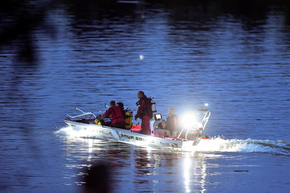 The Knox County Rescue Squad searches the Tennessee River following a helicopter crash Aug. 3, 2020. Knoxville businessman Jim Clayton, who was piloting the helicopter, escaped through a broken window following the crash, according to NTSB documents, while two passengers escaped through a door. Jim's brother, Joe Clayton, drowned in the moments after the crash.