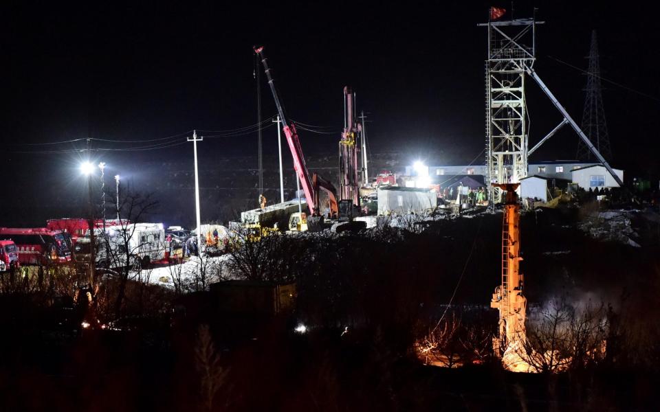 Rescue teams work on saving workers trapped underground after an explosion at the gold mine under construction in Qixia - Reuters