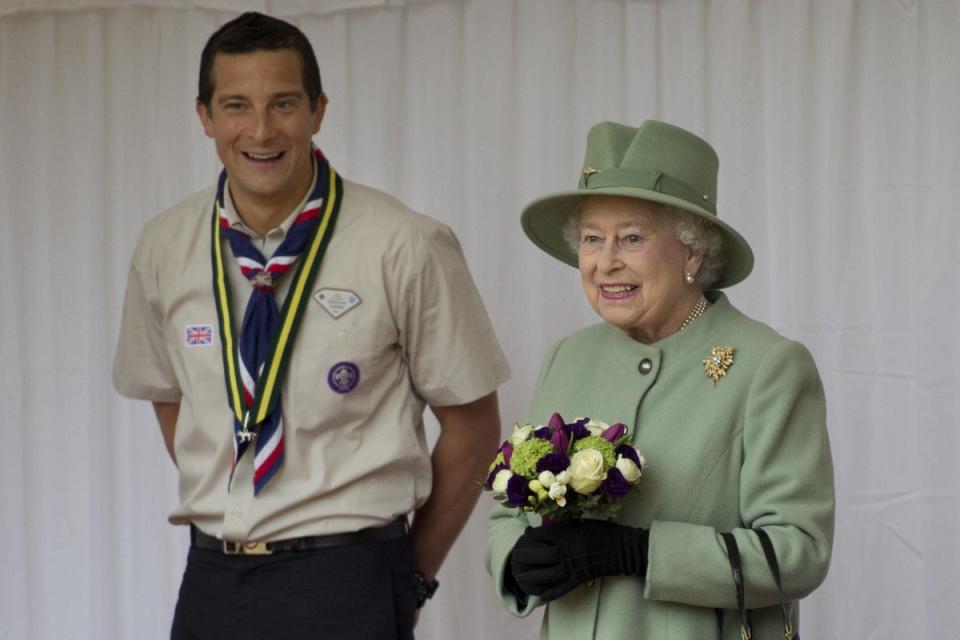 Chief Scout, Bear Grylls, left, watches as Queen Elizabeth II reviews the Queen’s Scouts at Windsor Castle (Ben Stansall/PA) (PA Archive)