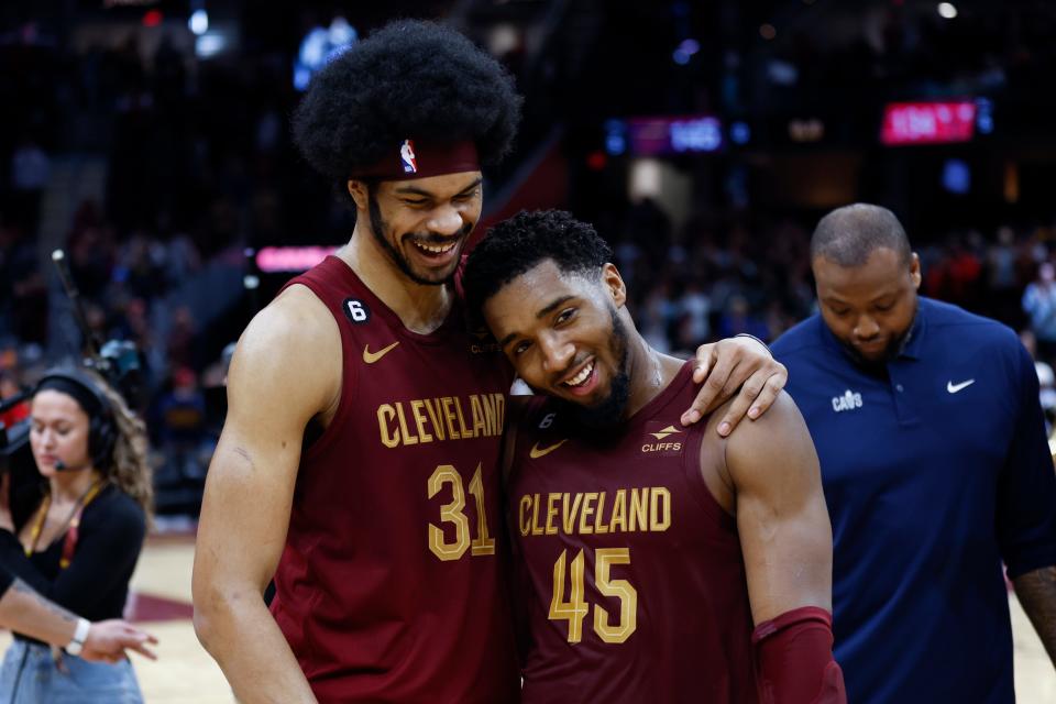 Cleveland Cavaliers guard Donovan Mitchell (45) celebrates with center Jarrett Allen (31) after an overtime win over the Chicago Bulls in an NBA basketball game, Monday, Jan. 2, 2023, in Cleveland. (AP Photo/Ron Schwane)