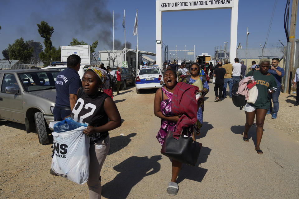 FILE - Female migrants exit the Pournara migrant reception center following fighting between rival groups inside the camp near the village of Kokkinotrimithia, on the outskirts of the capital Nicosia, Cyprus, Friday, Oct. 28, 2022. The president of Cyprus Nikos Christodoulides says on Tuesday, April 2, 2024, he has personally asked the head of the European Union's executive arm to intercede with Lebanese authorities so that they could put a stop to boat loads of Syrian refugees from heading to the east Mediterranean island nation. (AP Photo/Petros Karadjias, File)