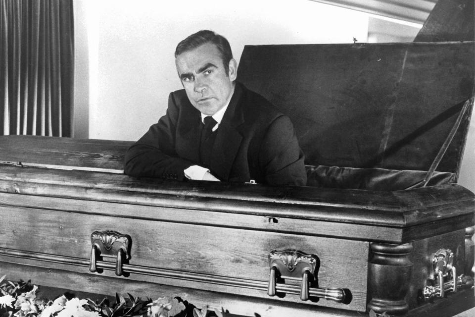 <p>Sean Connery sitting in a coffin in a scene from <em>Diamonds Are Forever.</em></p>