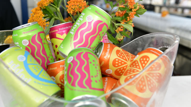 Cans of Poppi soda in plastic basket