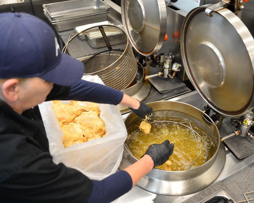 Hagerstown-based AC&T was picked by Herald-Mail readers recently as having the best gas station food in the Tri-State region.Dawn Cool, the kitchen manager at AC&T's Travel Center on Hopewell Road, loads recently breaded chicken into a pressure fryer.