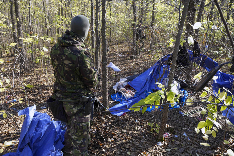 In this photo provided by the Serbian Interior Ministry, Serbian gendarmerie officers looking for migrants in a forest near the border between Serbia and Hungary, Serbia, Thursday, Nov. 2, 2023. Serbian police said Friday, Nov. 3, 2023 they made seven arrests on suspicion of smuggling people into Hungary as part of a days-long crackdown on irregular migration in the wake of a shooting last week in the border area that killed three migrants and wounded one. Reports of violence and gun battles have become common near the border between Serbia and Hungary, a European Union member state. (Serbian Ministry of Interior via AP)