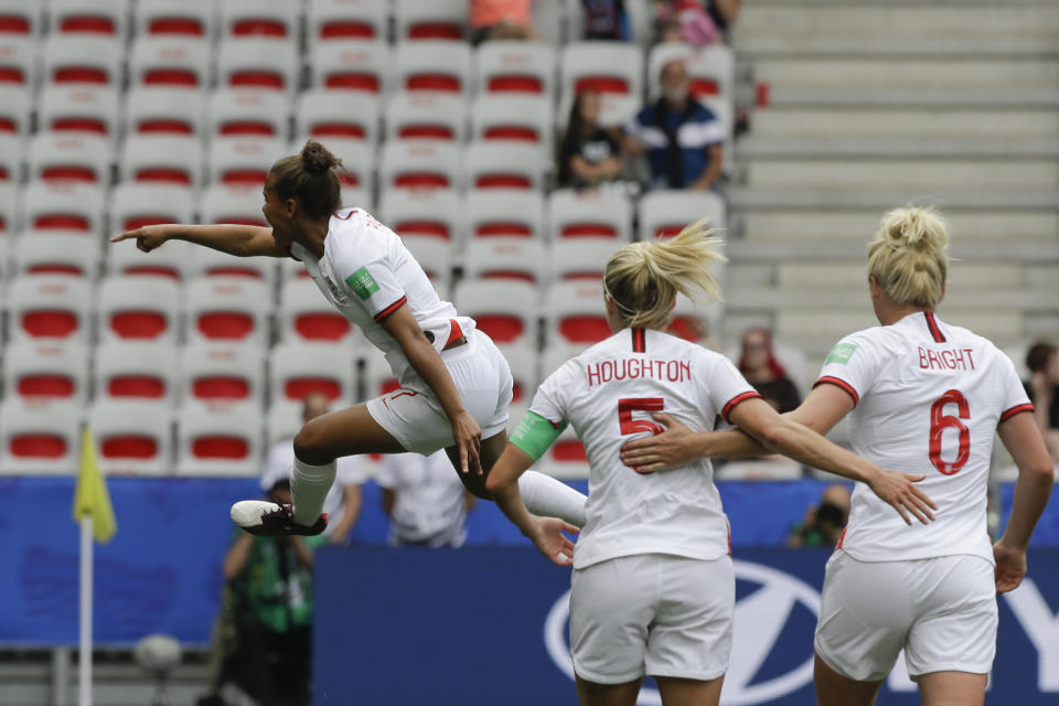 England's Nikita Parris, left, celebrates after scoring her side's opening goal on a penalty kick during the Women's World Cup Group D soccer match between England and Scotland in Nice, France, Sunday, June 9, 2019. (AP Photo/Claude Paris)