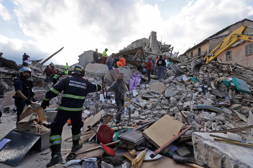 <p>Rescuers search for survivors through the rubble of collapsed buildings following an earthquake, in Amatrice, Italy, Wednesday, Aug. 24, 2016. (AP Photo/Alessandra Tarantino) </p>