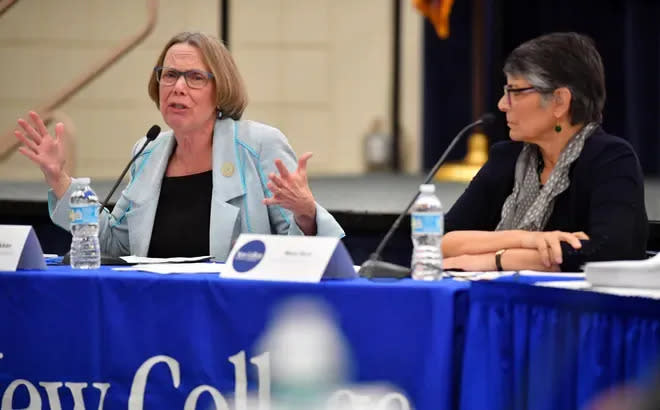 An emotional Patricia Okker, left, defends the New College curriculum just after the trustees fired her as president during a meeting Jan. 31. At right is Mary Ruiz, former board chair.