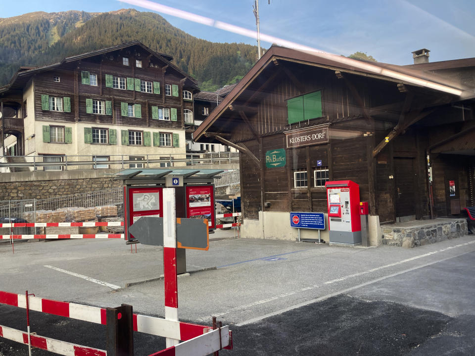 A train pass by traditional Swiss buildings on the way to Davos, Switzerland, Saturday, May 21, 2022. The World Economic Forum is encouraging European attendees to come to its exclusive gathering in the Swiss Alps by train. Its part of efforts to burnish the sustainability credentials for an event in Davos that conjures up up images of government leaders, billionaire elites and corporate titans jetting in on carbon-spewing private planes. (AP Photo/Kelvin Chan)