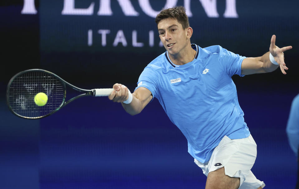 Greece's Michail Pervolarakis makes a forehand return to Spain's Pablo Carreno Busta during their ATP Cup match in Melbourne, Australia, Friday, Feb. 5, 2021.(AP Photo/Hamish Blair)