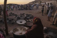 Sudanese women volunteer to cook for Tigray people who fled the conflict in Ethiopia's Tigray region, at Umm Rakouba refugee camp in Qadarif, eastern Sudan, Thursday, Nov. 26, 2020. Ethiopia's prime minister said Thursday the army has been ordered to move on the embattled Tigray regional capital after his 72-hour ultimatum ended for Tigray leaders to surrender, and he warned the city's half-million residents to stay indoors and disarm. (AP Photo/Nariman El-Mofty)