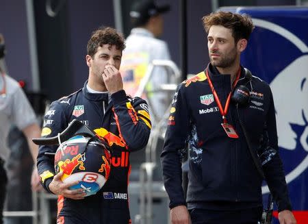 Formula One - F1 - Australian Grand Prix - Melbourne, Australia - 25/03/2017 Red Bull Racing driver Daniel Ricciardo of Australia reacts as he walks down pit lane after crashing out of the qualifying session. REUTERS/Brandon Malone