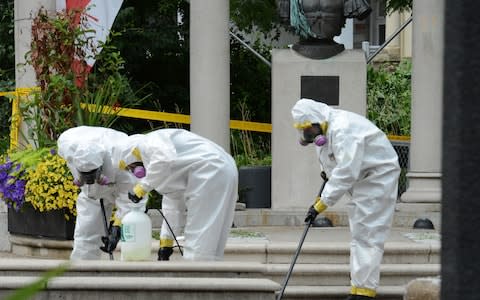 The crime scene is cleaned after the shooting on Sunday - Credit: AFP/Usman Khan