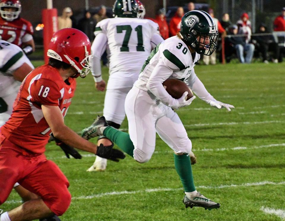 Dover’s Brett Davis, right, runs away from Spaulding’s Hunter Trueman during Week 4's game.