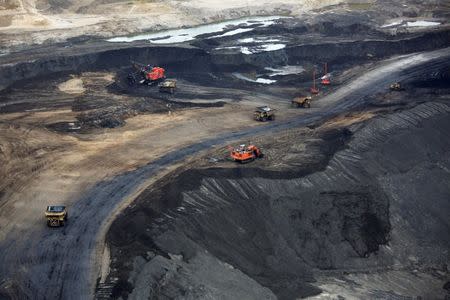 Heavy earth moving machinery move raw tars sands at the Syncrude tar sands mining operations near Fort McMurray, Alberta, Canada September 17, 2014. REUTERS/Todd Korol/Files