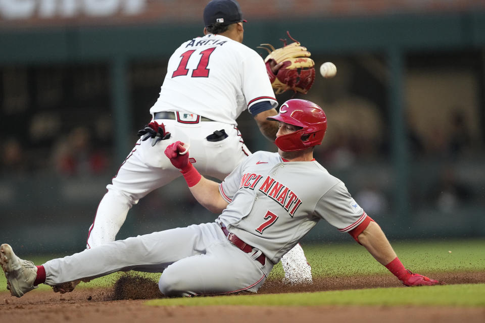 Cincinnati Reds' Spencer Steer (7) slides into second base with a double as Atlanta Braves shortstop Orlando Arcia (11) handles a late throw in the second inning of a baseball game, Monday, April 10, 2023, in Atlanta. (AP Photo/John Bazemore)