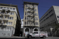 A hazardous material emergency truck is shown parked in front of the Abigail Hotel in San Francisco, Thursday, April 2, 2020. The hotel is one of several private hotels San Francisco has contracted with to take vulnerable people who show symptoms or are awaiting test results for the coronavirus. (AP Photo/Jeff Chiu)