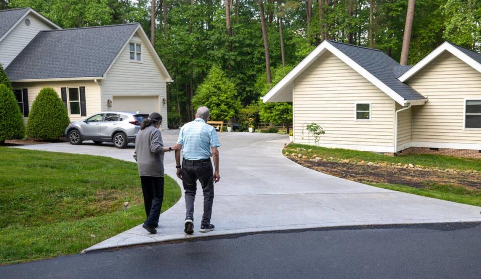 Abby and Bob Millhuaser return to their 940 sq. ft. accessory dwelling unit, built just feet from Abby’s daughter’s residence on Alloway Court after a short stroll in the neighborhood on Friday, April 19, 2024 in Raleigh, N.C. Robert Willett/rwillett@newsobserver.com