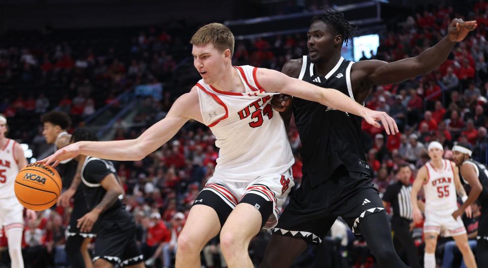 Utah Utes center Lawson Lovering (34) is defended by Hawaii Warriors center Mor Seck (23) at the Delta Center in Salt Lake City on Thursday, Nov. 30, 2023. | Jeffrey D. Allred, Deseret News