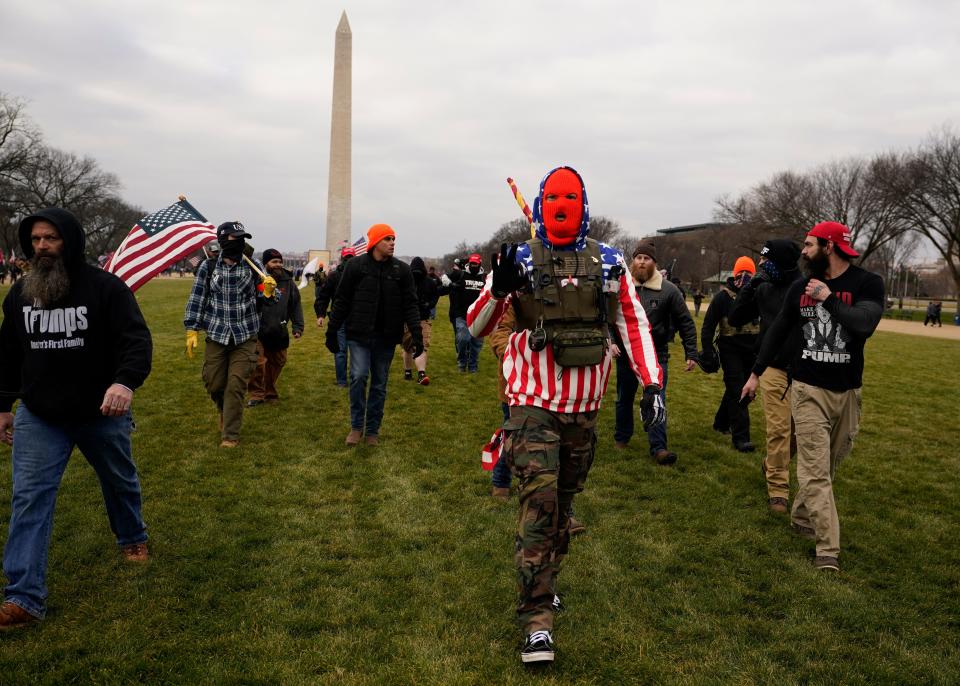 People march with those who say they are members of the Proud Boys in Washington on Jan. 6 in support of President Donald Trump.