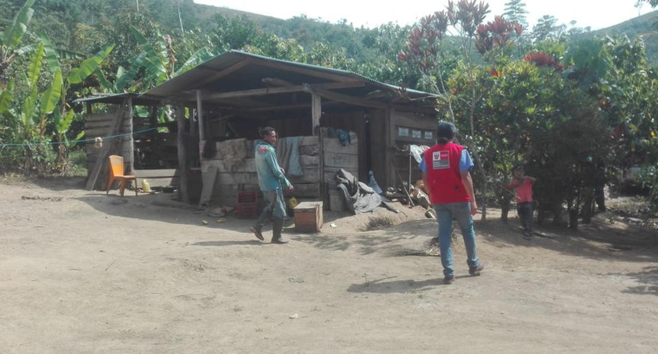 Two men walk near the wooden shack. Source: Real Press/Australscope