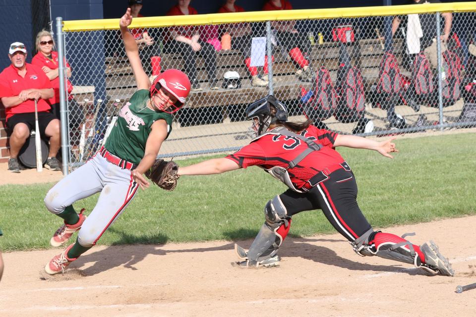 Oak Harbor's Porter Gregory tries to avoid a tag at home plate.