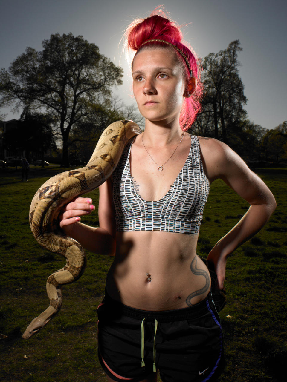 <p>“Lilly Elkin, a graduate-school student studying environmental biology, stands in Overland Park with her pet snakes Eago and Cleo. She is skeptical about parts of the global warming debate. She voted for Trump.” (Photograph and caption by Naomi Harris) </p>