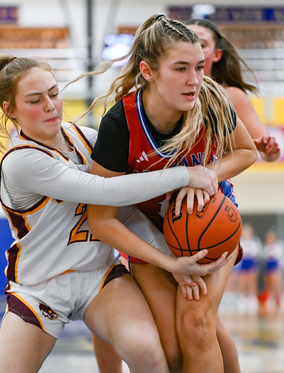 Bloomington North’s Ellie Livingston (22) forces a jump ball with Martinsville’s Brynlee Hamblin during the IHSAA first round sectional game at Mooresville High School on Tuesday, Jan. 30, 2024.