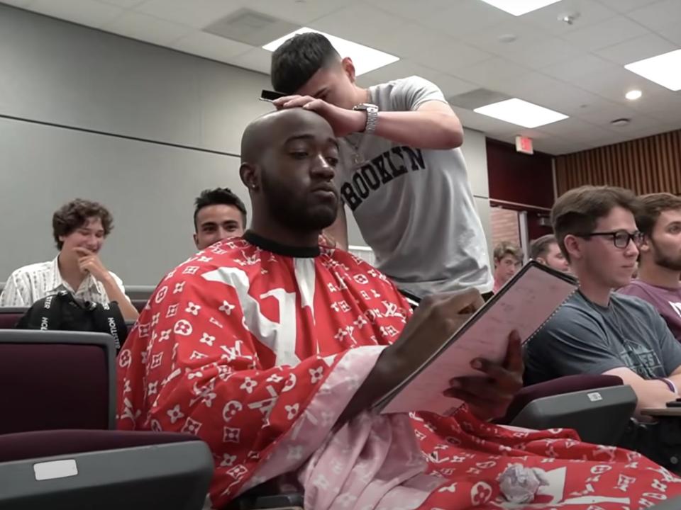 A picture of JiDion getting a haircut in a lecture.