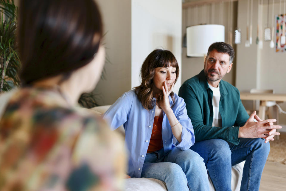 A couple talking to their daughter