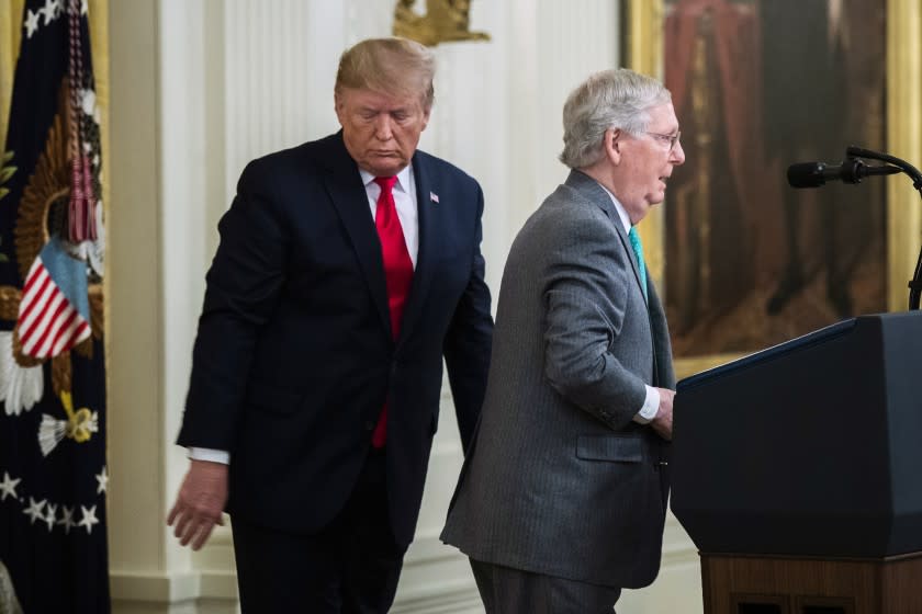 FILE - In this Nov. 6, 2019, file photo President Donald Trump invites Senate Majority Leader Mitch McConnell, R-Ky., to speak in the East Room of the White House during a ceremony where Trump spoke about his judicial appointments in Washington. Trump is nominating Justin Walker, a 37-year-old judge and former clerk to Supreme Court Justice Brett Kavanaugh, to a seat on the powerful U.S. Court of Appeals for the District of Columbia Circuit. Walker of Kentucky is one of the youngest federal judges in the country. He has deep ties to McConnell. (AP Photo/Manuel Balce Ceneta, File)