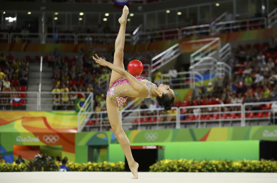 <p>Laura Zeng (USA) of USA competes using the ball. (Reuters) </p>
