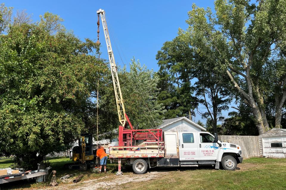 Lynn Rosenquist, who owns a well-repair business, sets up a small crane to remove the broken casing of an old well near Fort Dodge, Iowa.