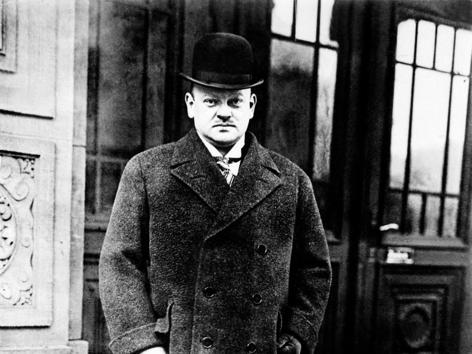 Gustav Stresemann looking stern with a top hat and coat on.