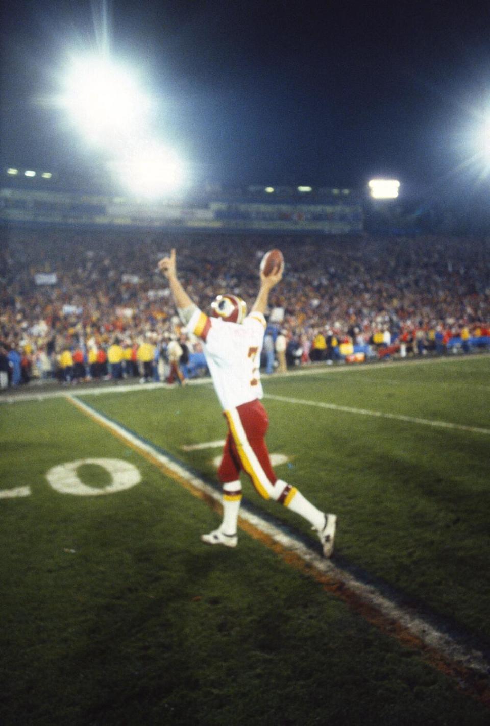 Joe Theismann runs off the field after winning Super Bowl XVII.